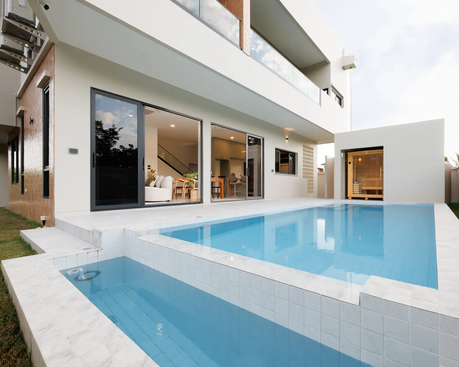 Warm light across the Villa Alive pool courtyard