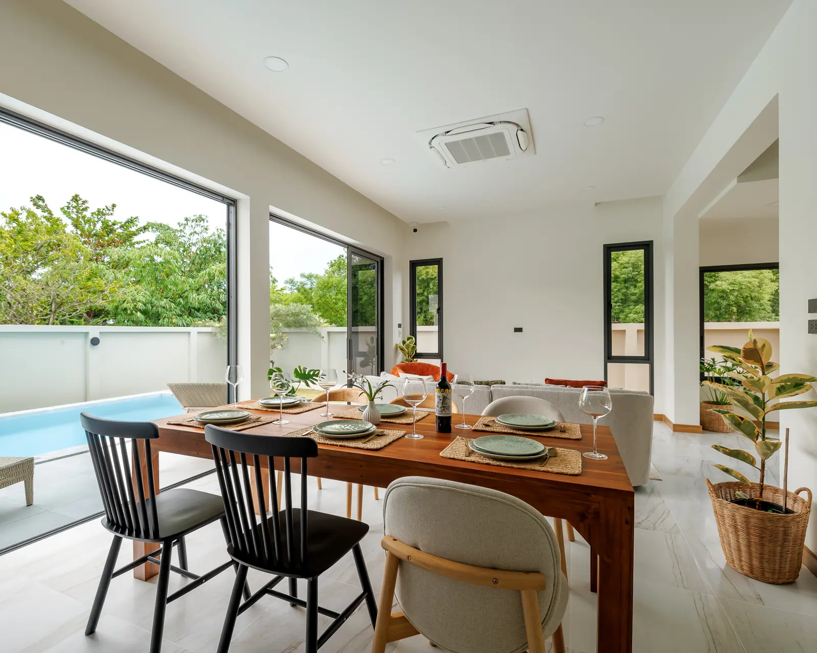 Open living and dining areas connecting to the Villa Alive pool