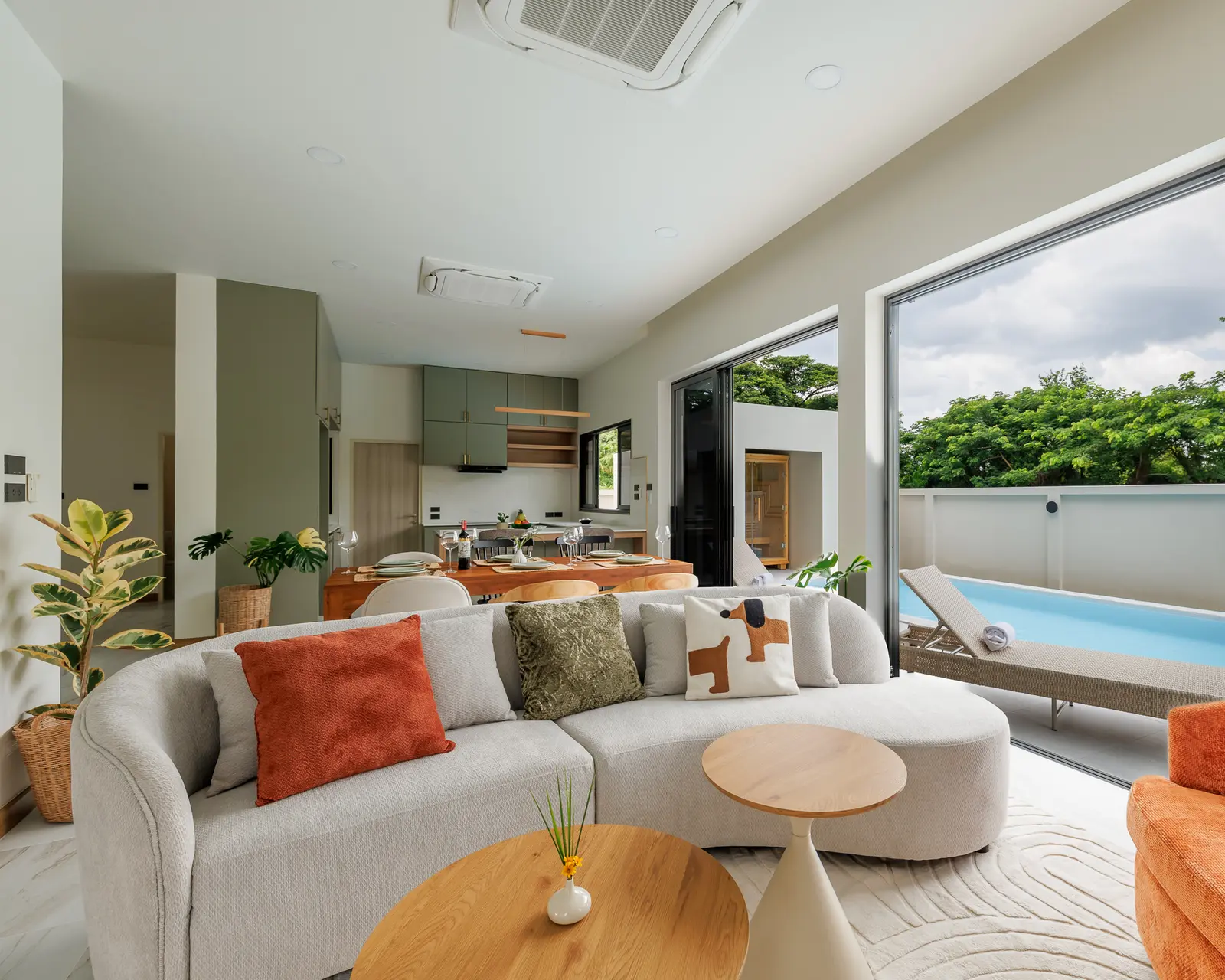 A bright living room opening directly to the private pool